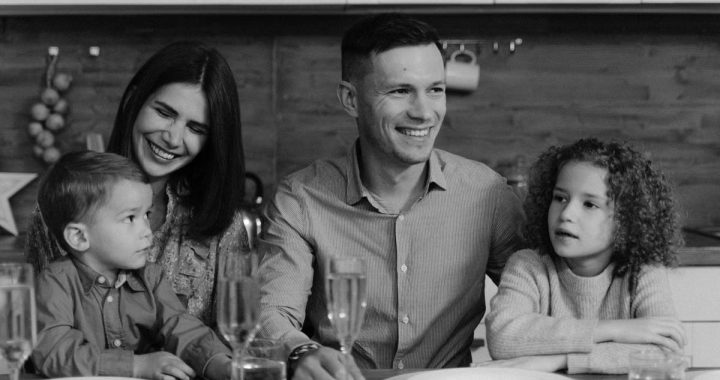 Smiling family enjoying quality time together at dining table in cozy kitchen.