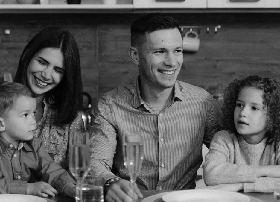 Smiling family enjoying quality time together at dining table in cozy kitchen.